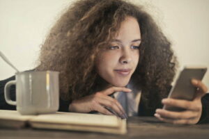 Sirona Therapy Westchester Putnam Rockland-Young woman of color looking at phone to learn about OSFED